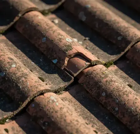 Drone image showing storm damage to slate roof for insurance claim.